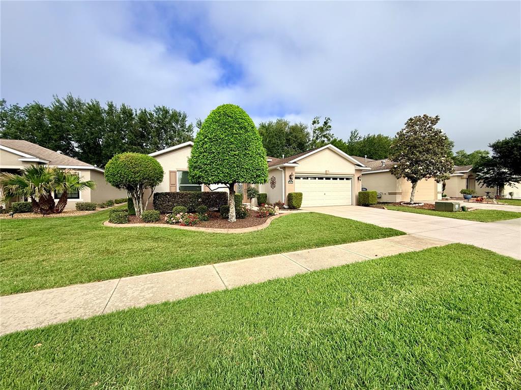 16296 Southwest 15th Court Ocala, FL 34473 - Photo 6 of 70 a front view of a house with garden