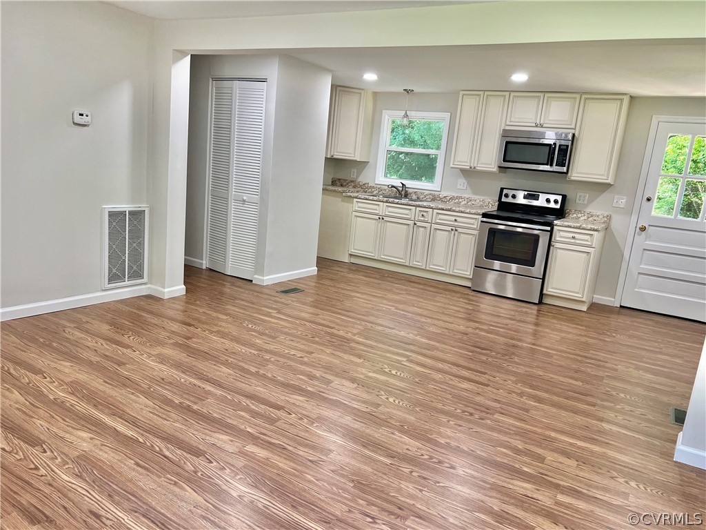 3440 The Loop Road Richmond, VA 23231 - Photo 11 of 22 a kitchen with granite countertop a refrigerator and a stove top oven