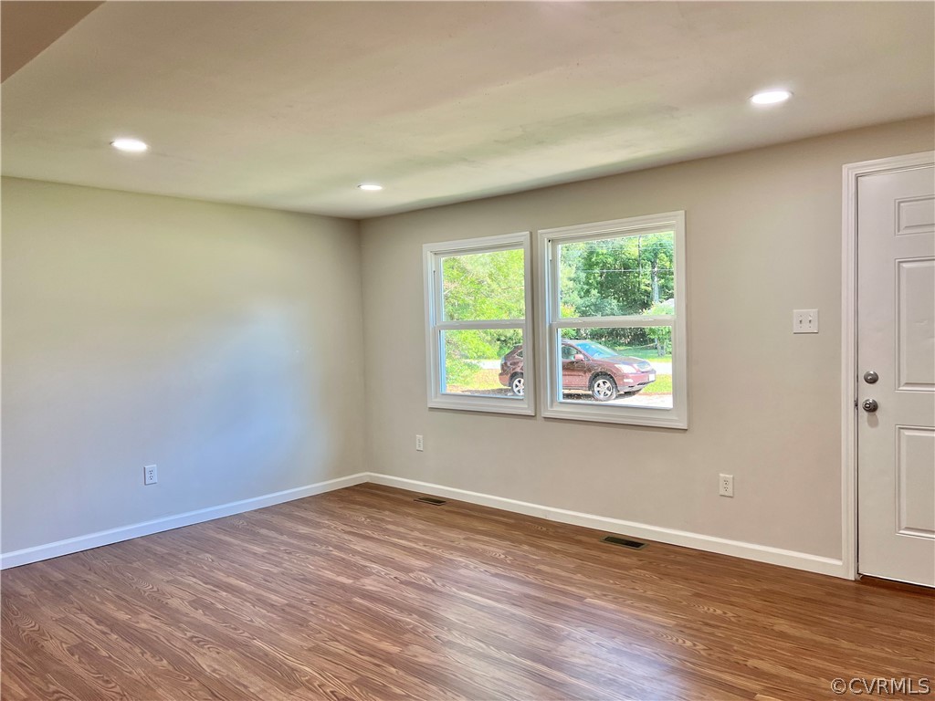 3440 The Loop Road Richmond, VA 23231 - Photo 12 of 22 an empty room with wooden floor and windows