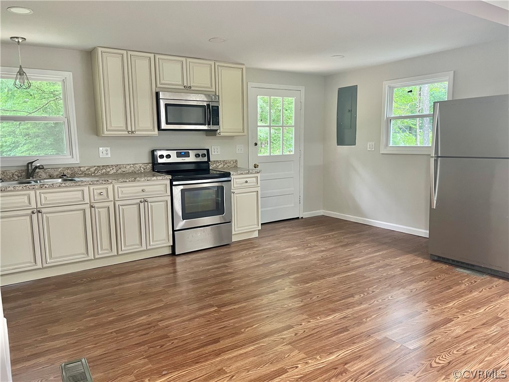 3440 The Loop Road Richmond, VA 23231 - Photo 4 of 22 a kitchen with granite countertop a stove a sink and a microwave