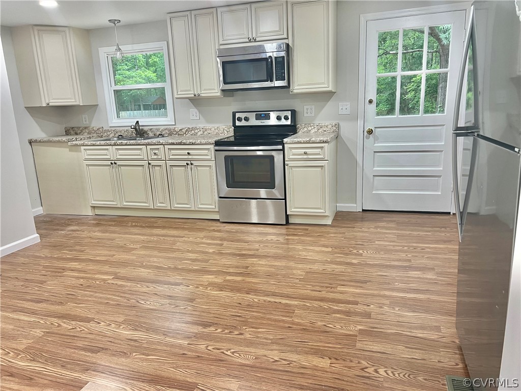3440 The Loop Road Richmond, VA 23231 - Photo 7 of 22 a kitchen with stainless steel appliances granite countertop a stove a sink and a microwave