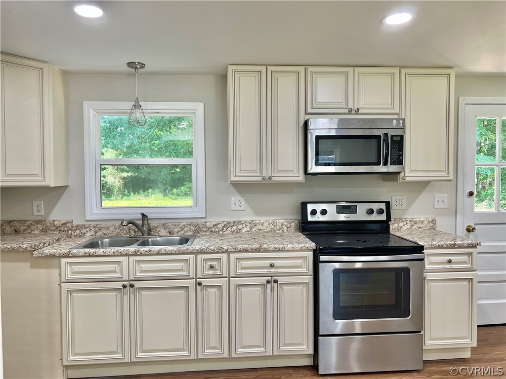 3440 The Loop Road Richmond, VA 23231 - Photo 10 of 22 a kitchen with granite countertop a stove a sink and a microwave