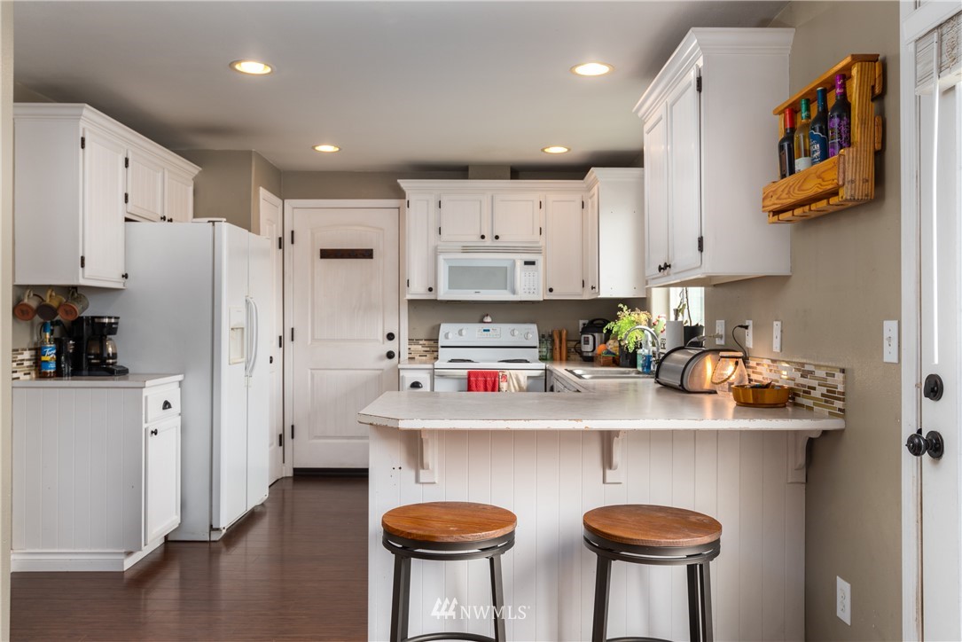 408 Rohrer Loop Sedro-Woolley, WA 98284 - Photo 8 of 20 a kitchen with stainless steel appliances granite countertop a refrigerator and a stove top oven