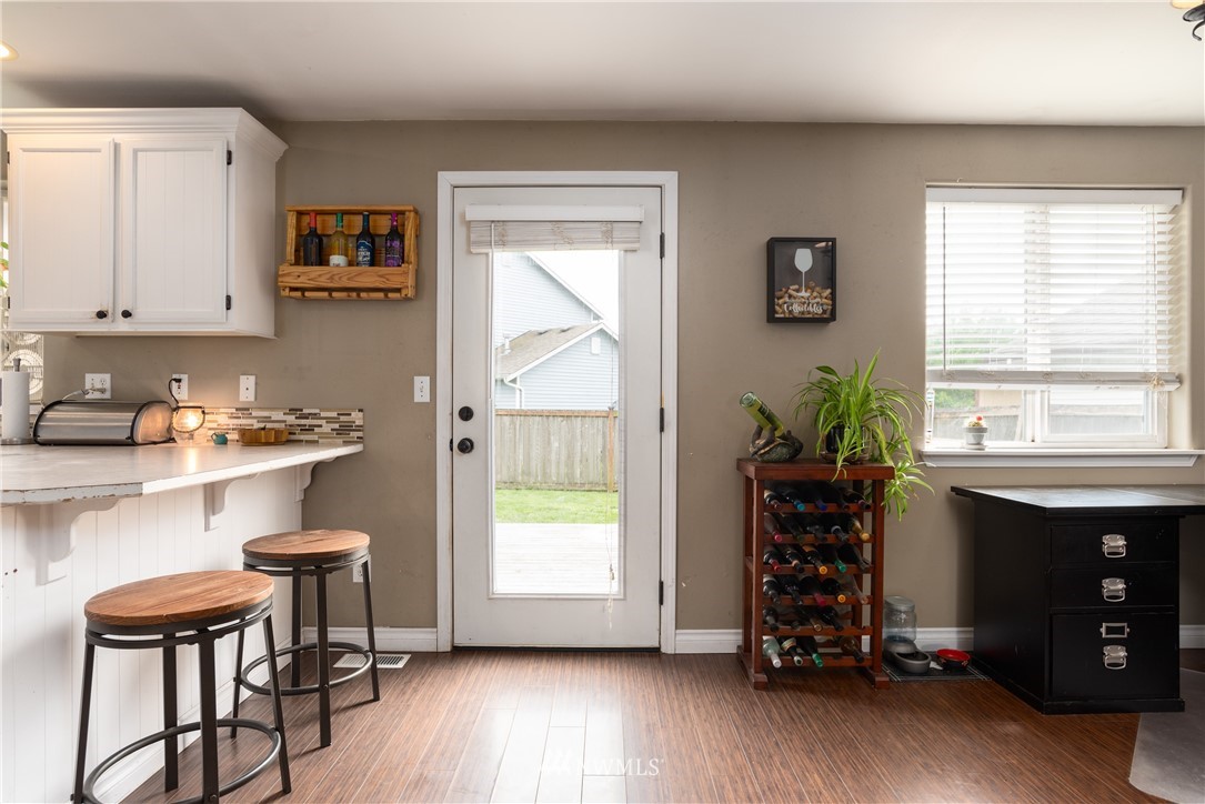 408 Rohrer Loop Sedro-Woolley, WA 98284 - Photo 9 of 20 a kitchen with stainless steel appliances a table and chairs in it