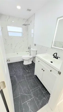 a bathroom with a sink a toilet and mirror