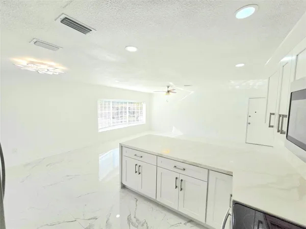 a view of a kitchen with cabinets
