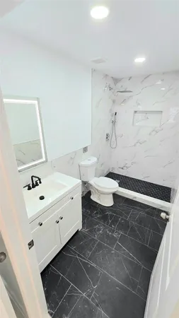 a bathroom with a sink toilet and mirror