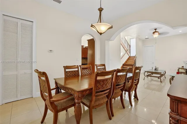 a kitchen with granite countertop white cabinets and stainless steel appliances