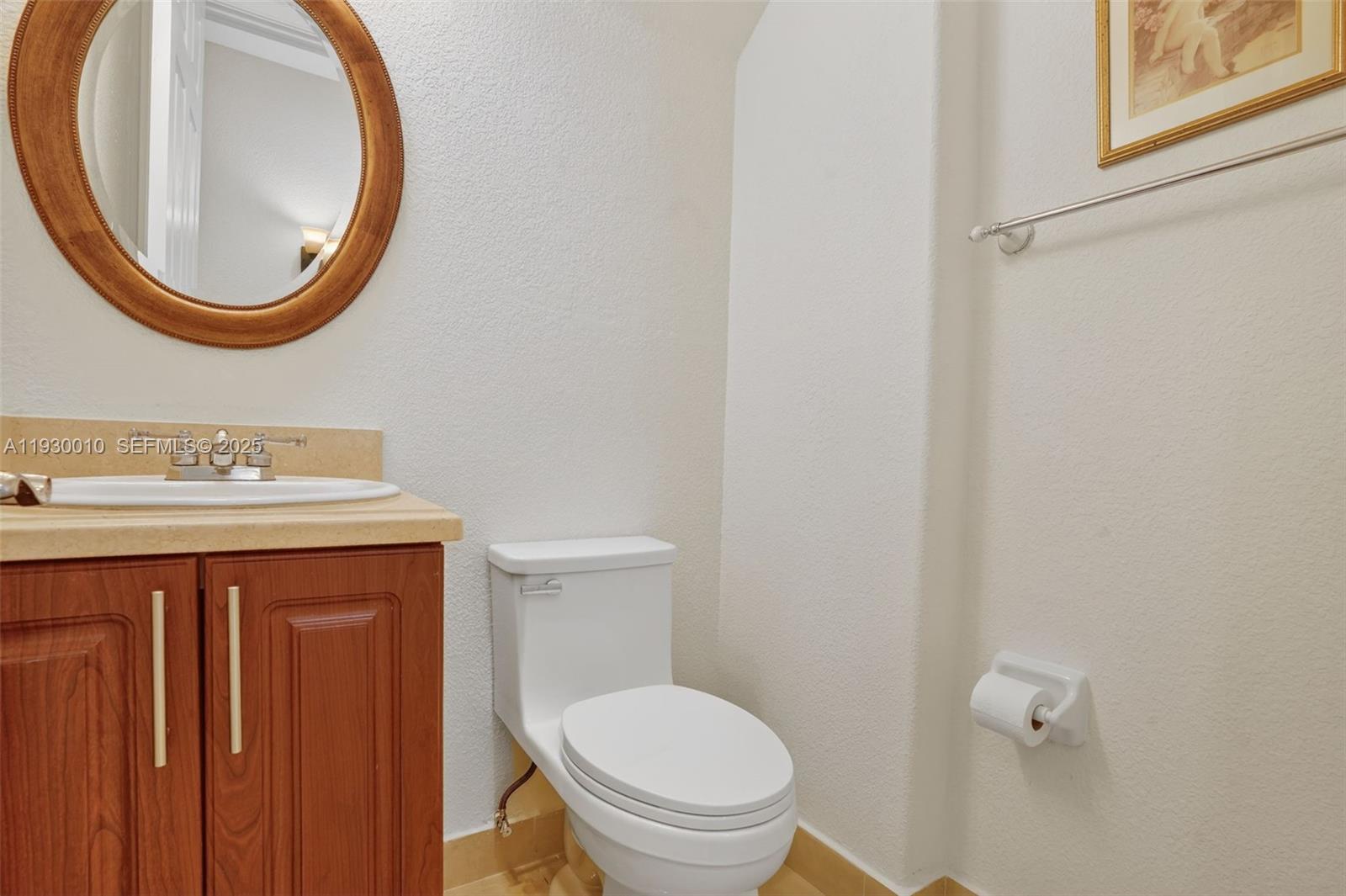 2913 Southwest 13th Street Miami, FL 33145 - Photo 18 of 55 a bathroom with a toilet a sink and a mirror