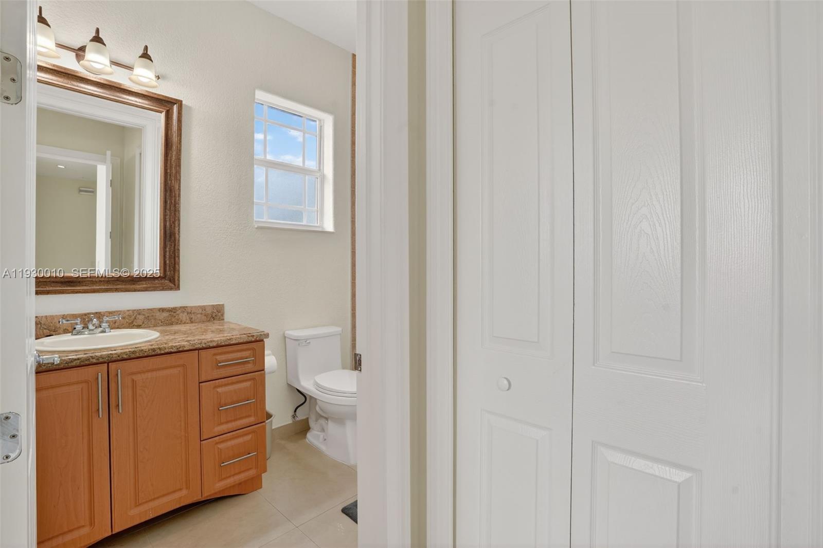 2913 Southwest 13th Street Miami, FL 33145 - Photo 33 of 55 a bathroom with a granite countertop toilet and sink
