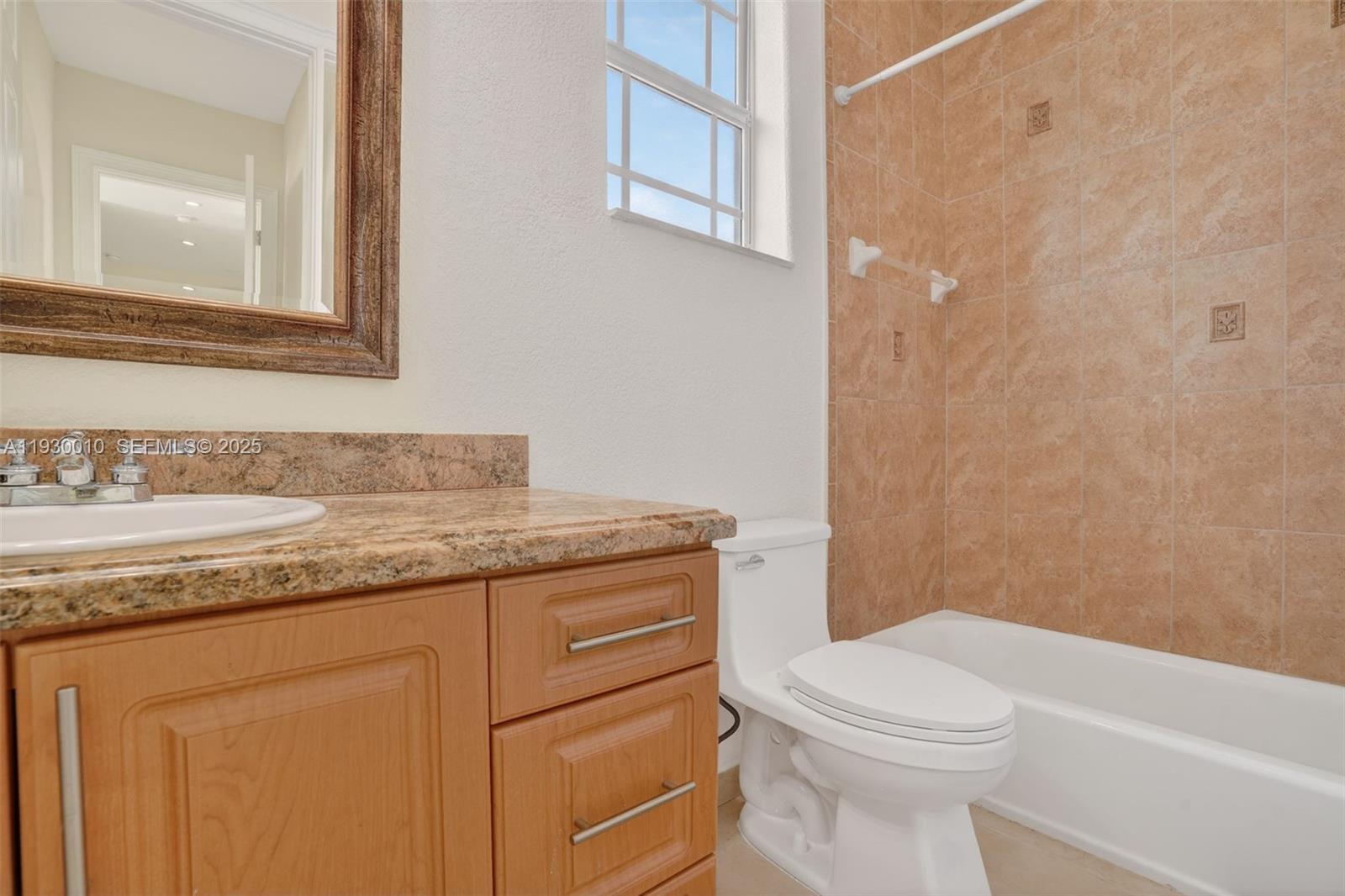 2913 Southwest 13th Street Miami, FL 33145 - Photo 34 of 55 a bathroom with a granite countertop toilet sink and mirror