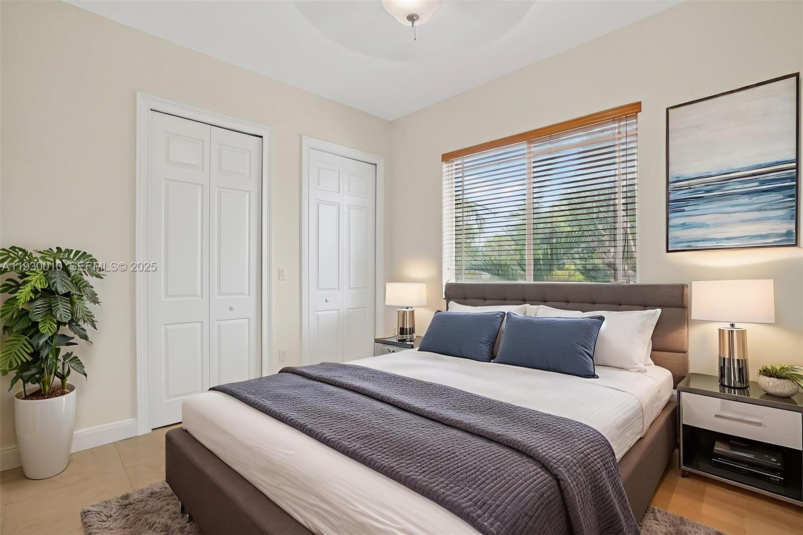 2913 Southwest 13th Street Miami, FL 33145 - Photo 36 of 55 a bedroom with a large bed and a potted plant