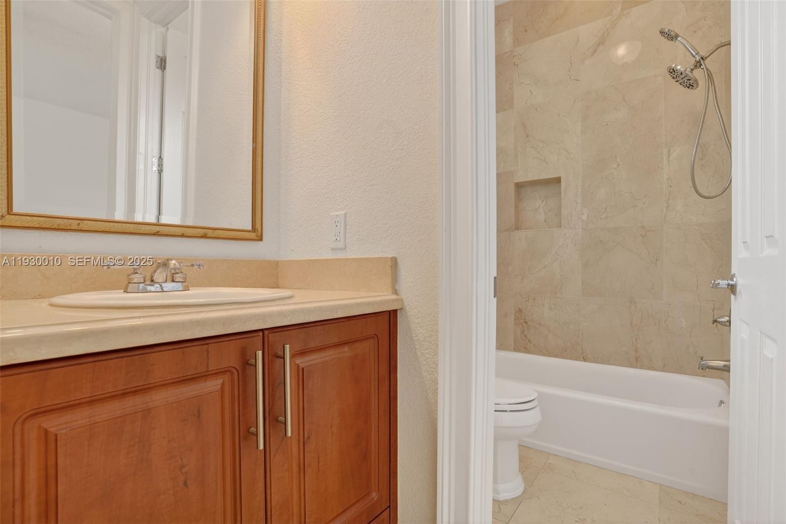 2913 Southwest 13th Street Miami, FL 33145 - Photo 38 of 55 a bathroom with a granite countertop sink toilet and shower