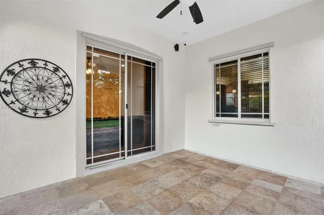 a front view of a house with a yard and potted plants