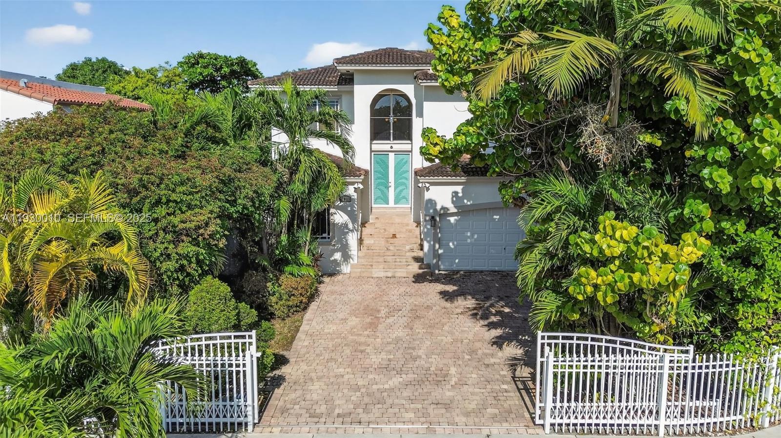 2913 Southwest 13th Street Miami, FL 33145 - Photo 47 of 55 a front view of a house with a yard and potted plants
