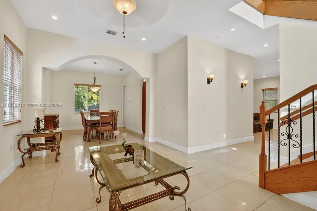 a view of a dining room with furniture and a chandelier