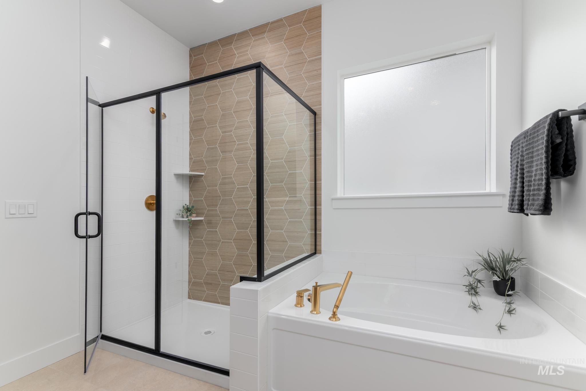 8569 South Silver Smog Way Meridian, ID 83642 - Photo 13 of 14 Bathroom featuring a bath and a stall shower