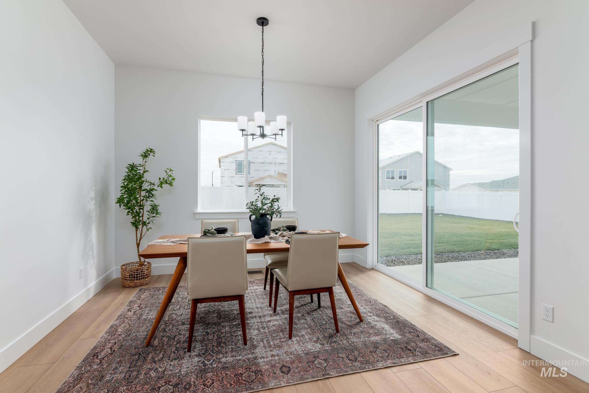 8569 South Silver Smog Way Meridian, ID 83642 - Photo 8 of 14 Dining area featuring hanging lights and light wood finished floors