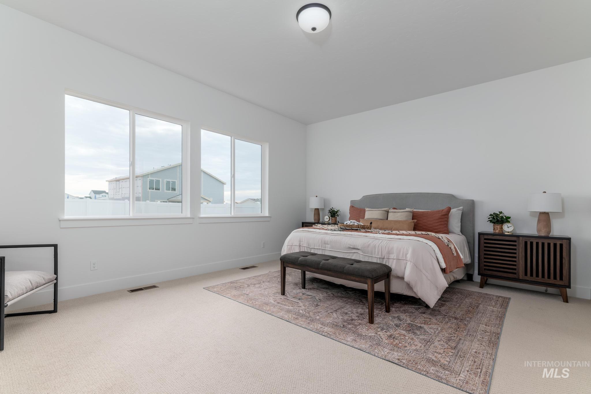 8569 South Silver Smog Way Meridian, ID 83642 - Photo 9 of 14 Bedroom with light colored carpet and baseboards