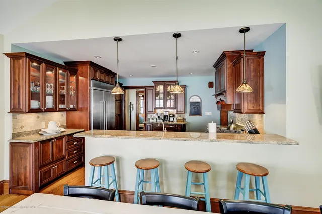 a large kitchen with a table and chairs