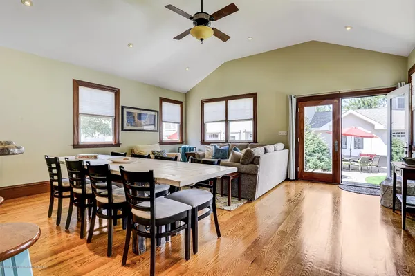 a view of a dining room and livingroom with furniture window and wooden floor