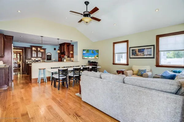 a living room with furniture wooden floor and a window