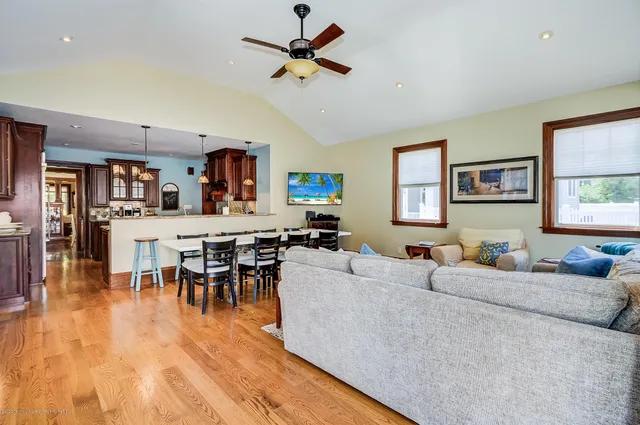 a living room with furniture wooden floor and a window