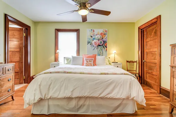 a bedroom with a bed and a painting on the wall