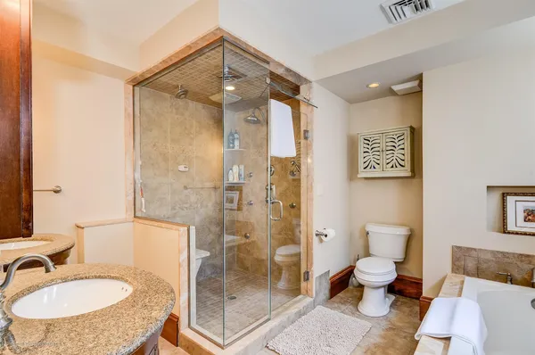 a bathroom with a sink toilet and shower