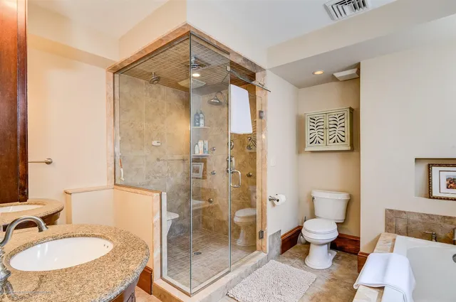 a bathroom with a sink toilet and shower