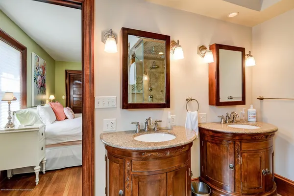 a en suite bathroom with a sink double vanity and a mirror
