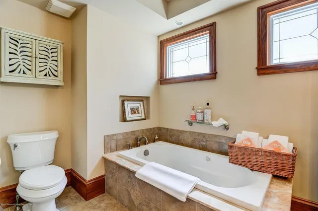 a bathroom with a bathtub and a toilet