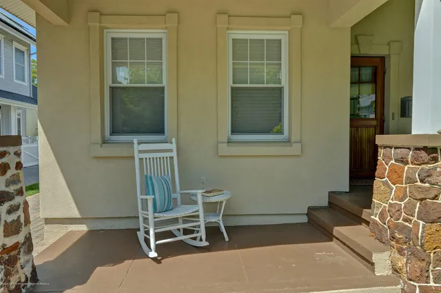 a balcony with table and chairs