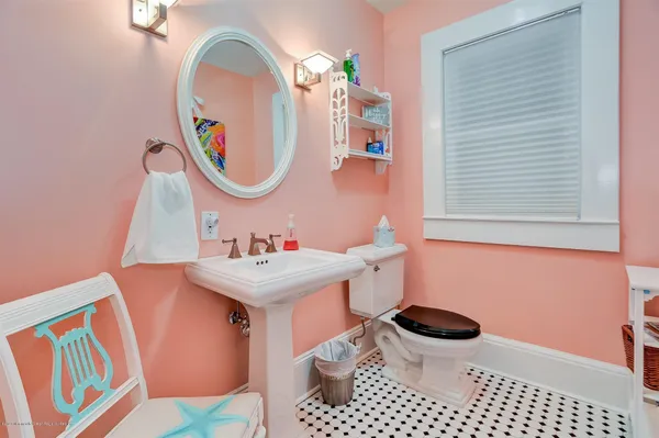 a bathroom with a sink a toilet and a mirror