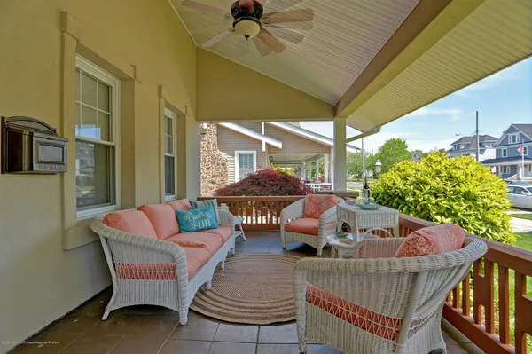 a balcony with furniture and a potted plant