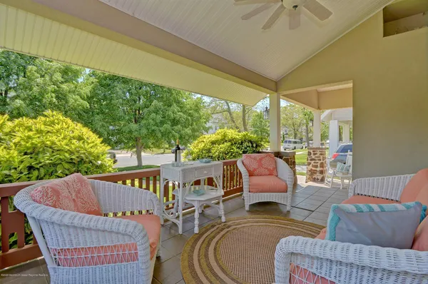 a balcony with furniture and a potted plant