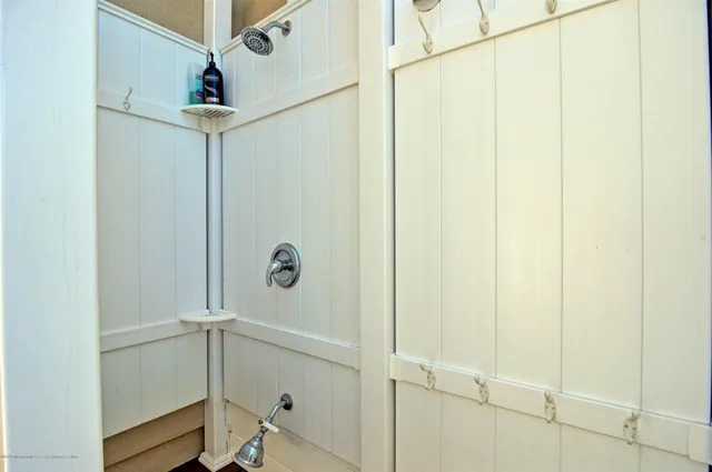 a bathroom with a glass shower door