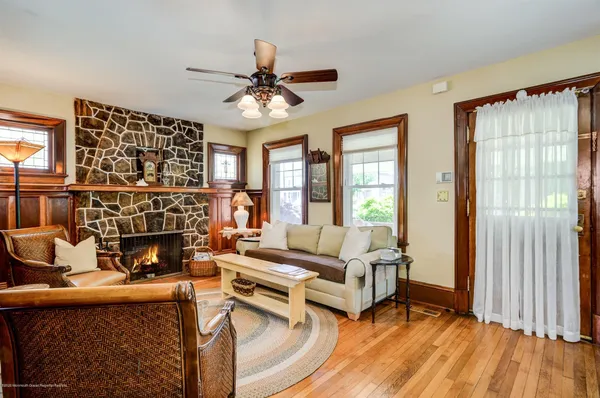 a living room with furniture a fireplace and a large window