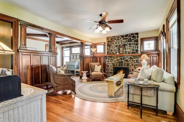 a living room with fireplace furniture and a large window