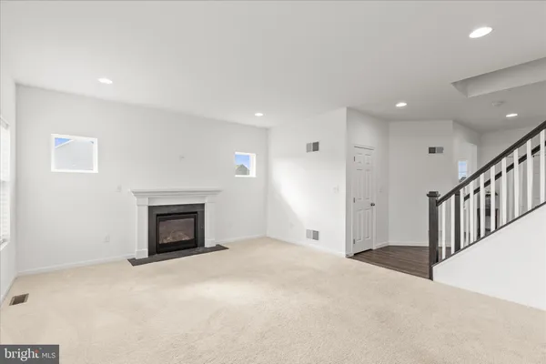 a view of an empty room with a fireplace