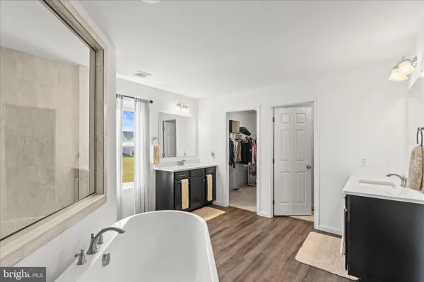 a white bath tub sitting next to a white sink
