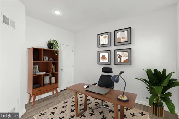 a bedroom with furniture and a potted plant