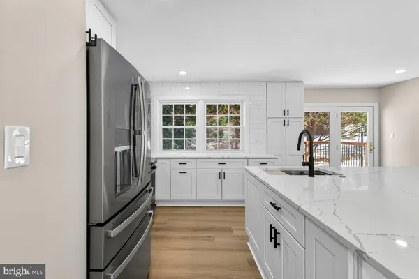 a kitchen with stainless steel appliances granite countertop a stove refrigerator sink and microwave