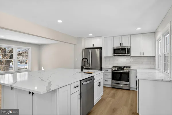 a kitchen with cabinets and a stove
