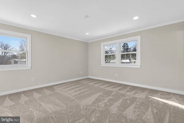 an empty room with windows and closet