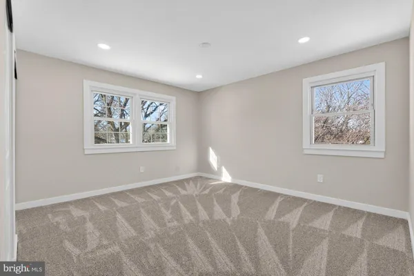 a bathroom with a granite countertop toilet sink and mirror