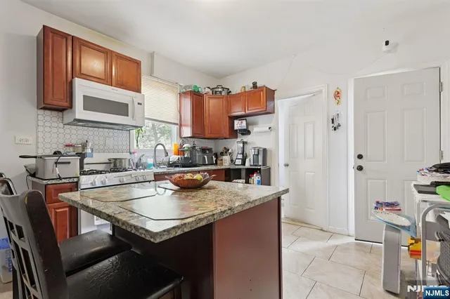 a kitchen with a stove a sink and a refrigerator