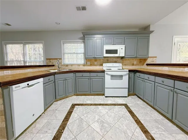 a kitchen with a sink stove and cabinets