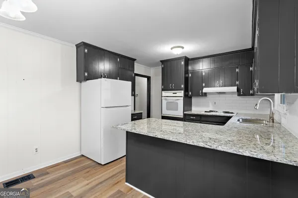 a kitchen with a sink stove and refrigerator