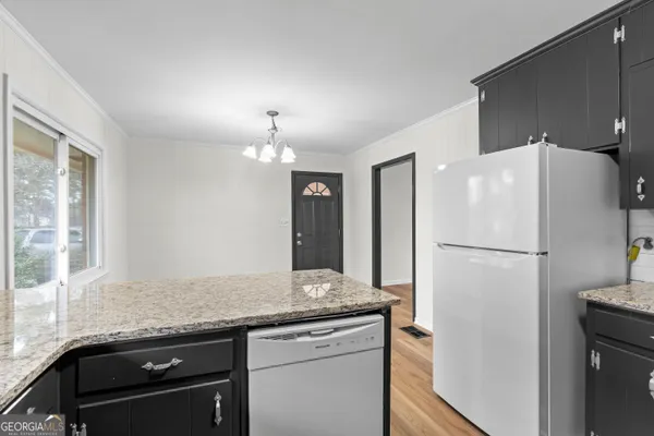 a kitchen with stainless steel appliances granite countertop a refrigerator a sink a stove a microwave and island